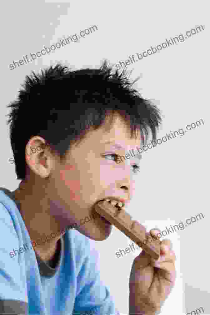Photo Of A Young Boy Happily Eating A Chocolate Bar, Conveying The Irresistible Allure Of Chocolate. The Chocolate Touch Patrick Skene Catling